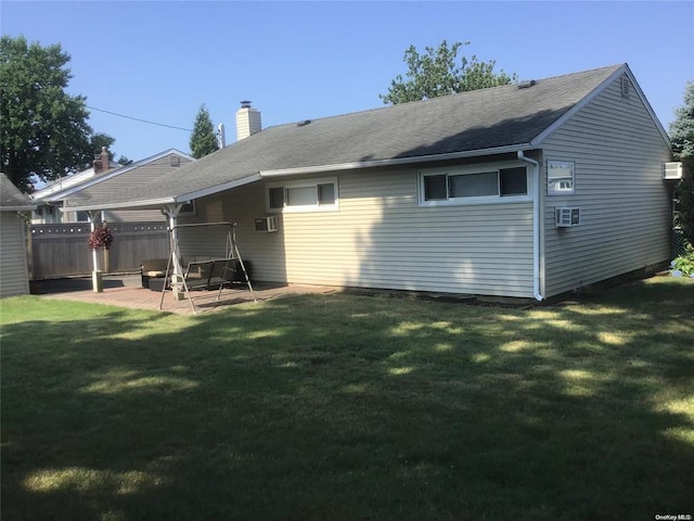 back of house featuring a patio area and a yard