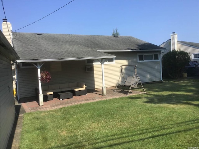 rear view of property with a patio area, a yard, and an outdoor hangout area