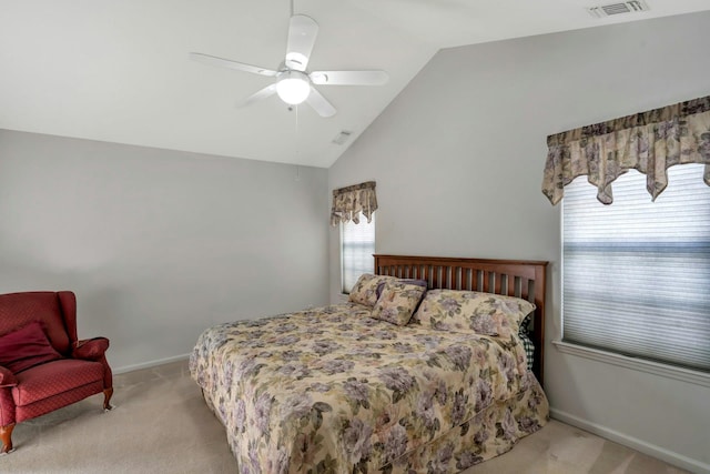 bedroom featuring ceiling fan, light carpet, and vaulted ceiling