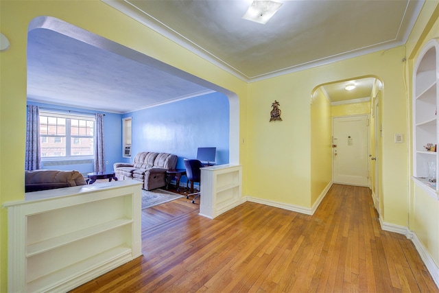 hall with crown molding and light wood-type flooring