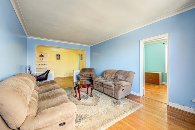 living room featuring wood-type flooring and crown molding