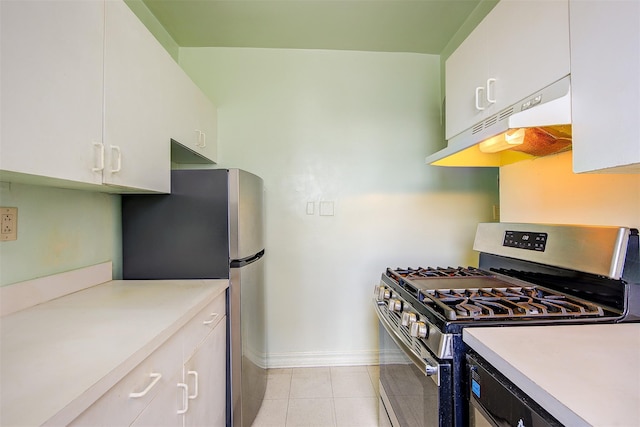 kitchen featuring white cabinetry, stainless steel appliances, and light tile patterned flooring