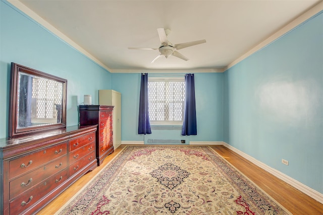 bedroom featuring crown molding, ceiling fan, and light hardwood / wood-style floors