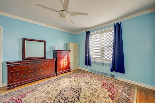 bedroom featuring hardwood / wood-style flooring and ceiling fan