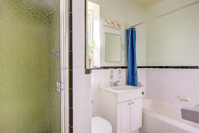 full bathroom featuring vanity, toilet, independent shower and bath, and tile walls