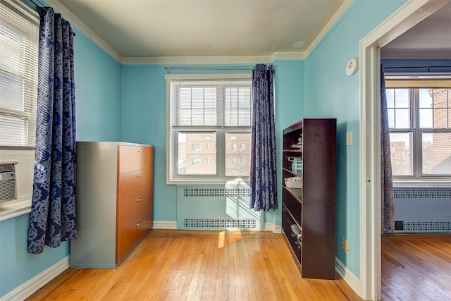 interior space featuring radiator heating unit and light wood-type flooring