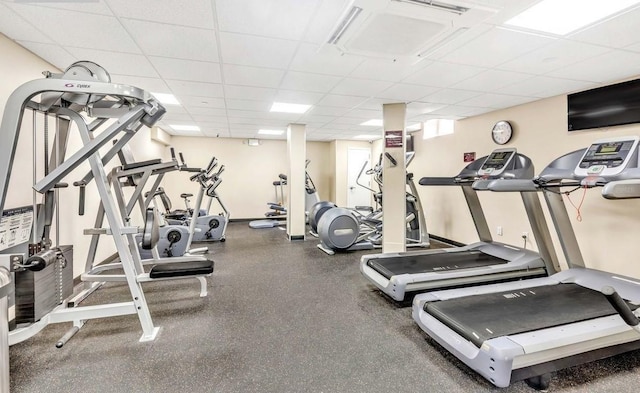 gym with a paneled ceiling