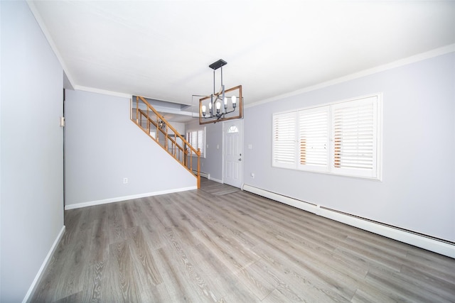 unfurnished living room with a baseboard heating unit, a notable chandelier, ornamental molding, and light hardwood / wood-style floors