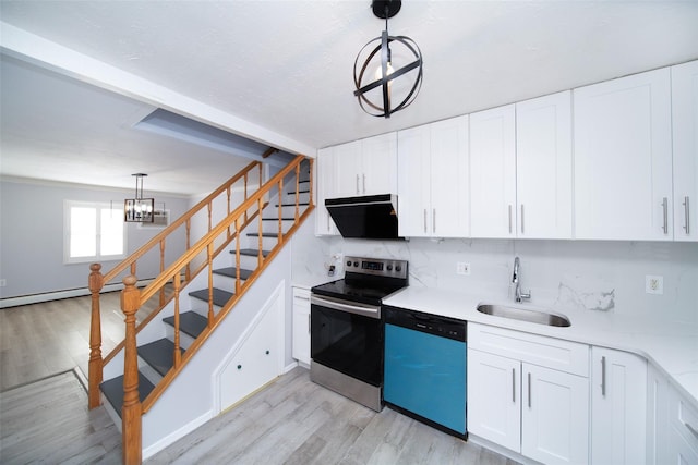 kitchen with extractor fan, appliances with stainless steel finishes, pendant lighting, white cabinetry, and sink