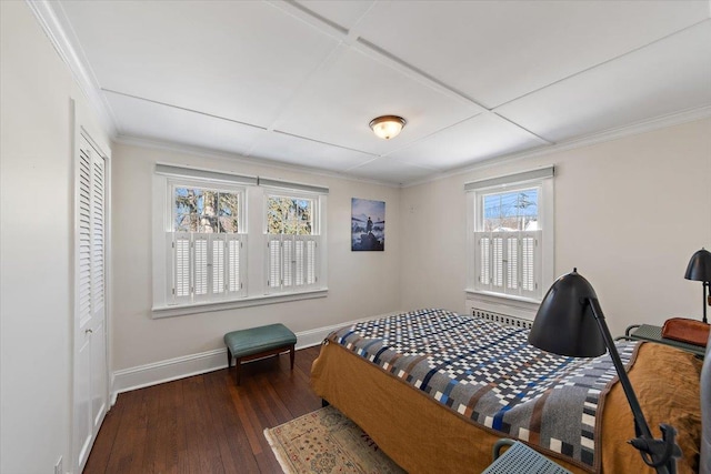 bedroom featuring a closet, ornamental molding, and dark hardwood / wood-style floors