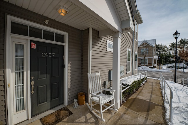 view of snow covered property entrance