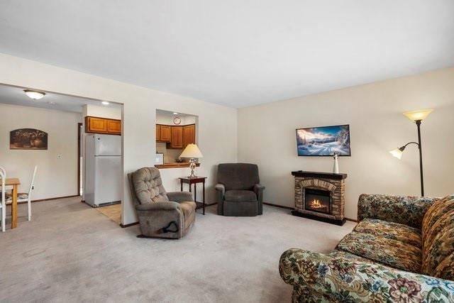 living room with a stone fireplace and light colored carpet