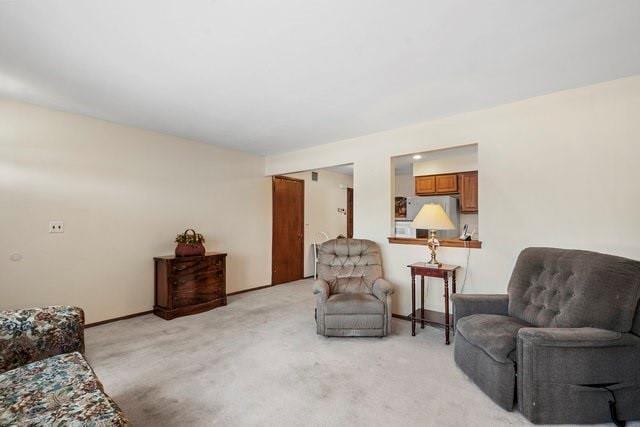 living area featuring light colored carpet