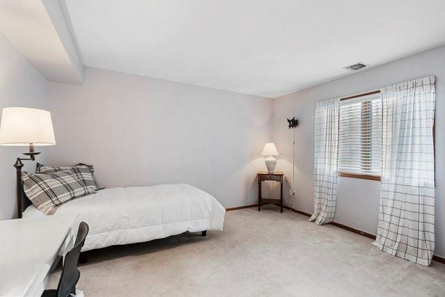 bedroom featuring light colored carpet