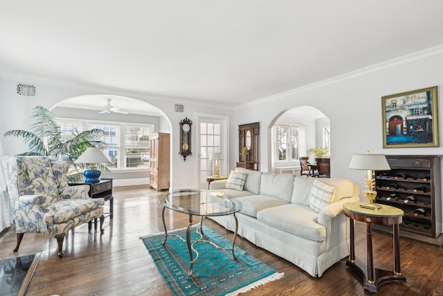 living room with dark hardwood / wood-style flooring and ornamental molding