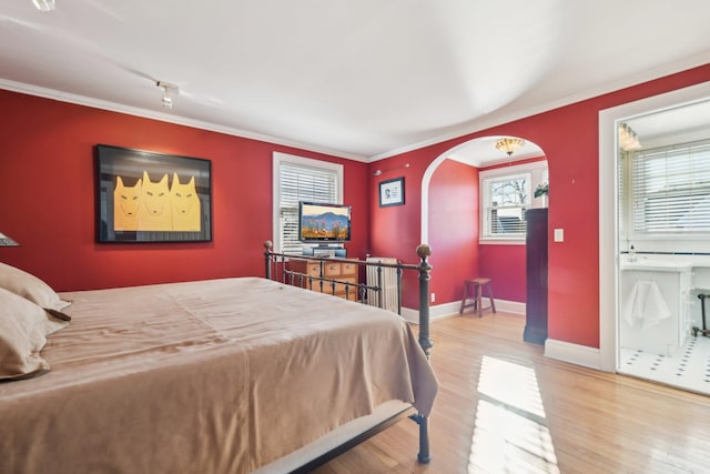 bedroom with wood-type flooring and ornamental molding