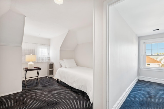 carpeted bedroom featuring lofted ceiling and radiator heating unit