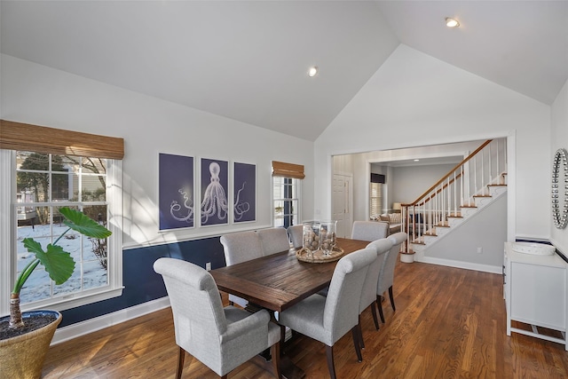 dining space featuring high vaulted ceiling and dark hardwood / wood-style flooring