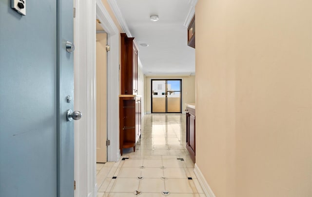 hallway with crown molding and light tile patterned flooring