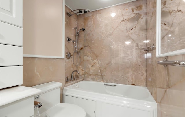 bathroom with tiled shower / bath, toilet, and tile walls