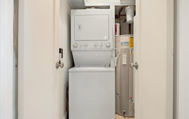 laundry room featuring stacked washer and dryer and water heater