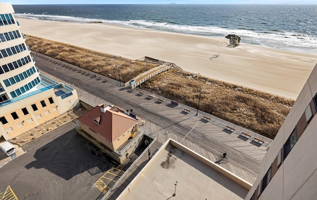 bird's eye view with a water view and a view of the beach