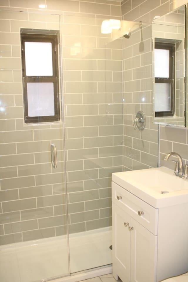 bathroom with vanity and walk in shower