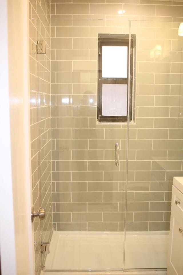 bathroom featuring an enclosed shower and vanity