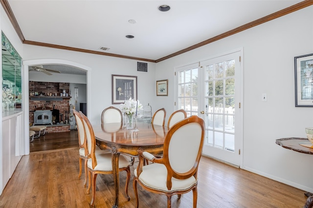 dining space with french doors, visible vents, and wood finished floors