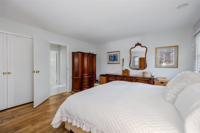 bedroom featuring a closet and light wood-style flooring