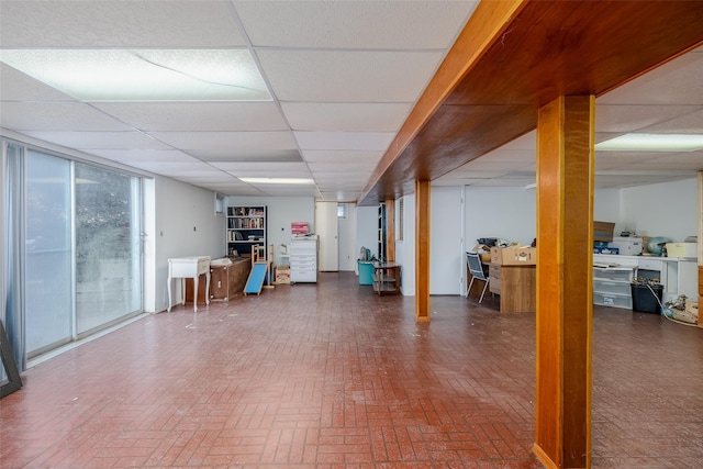 basement with a paneled ceiling