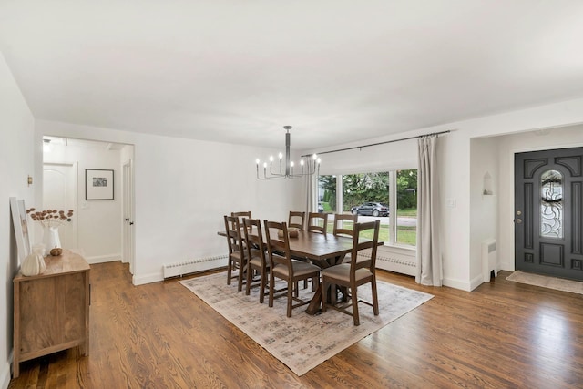 dining area featuring an inviting chandelier, radiator heating unit, a baseboard radiator, and dark hardwood / wood-style floors