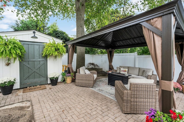 view of patio with a gazebo, a storage shed, and outdoor lounge area