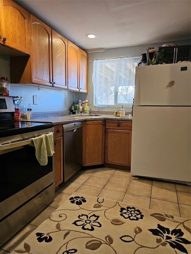 kitchen with light tile patterned flooring and appliances with stainless steel finishes