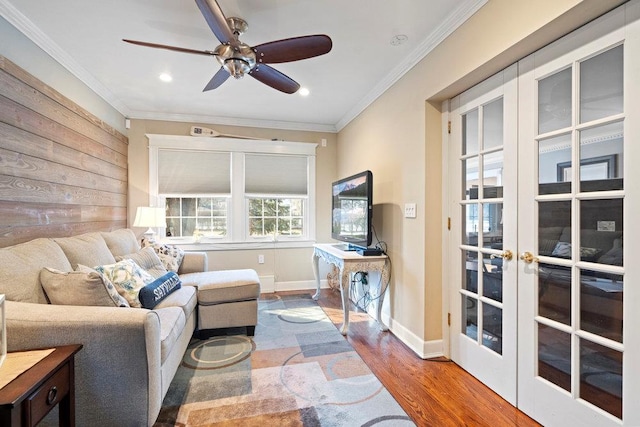 living room featuring wood-type flooring, ceiling fan, crown molding, and french doors