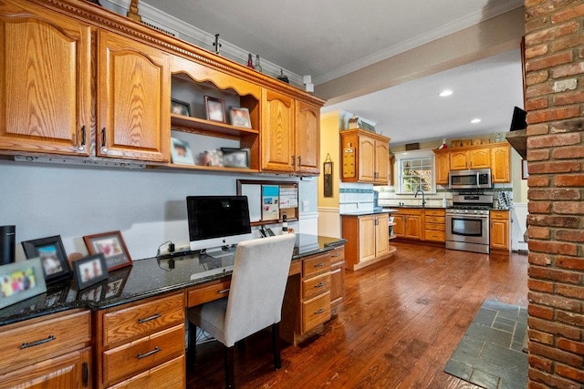 office area with sink, crown molding, dark wood-type flooring, and built in desk