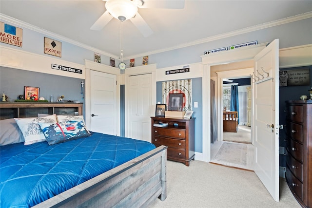 carpeted bedroom with crown molding, a closet, and ceiling fan