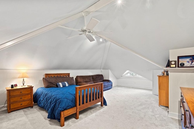 carpeted bedroom featuring lofted ceiling with beams and ceiling fan