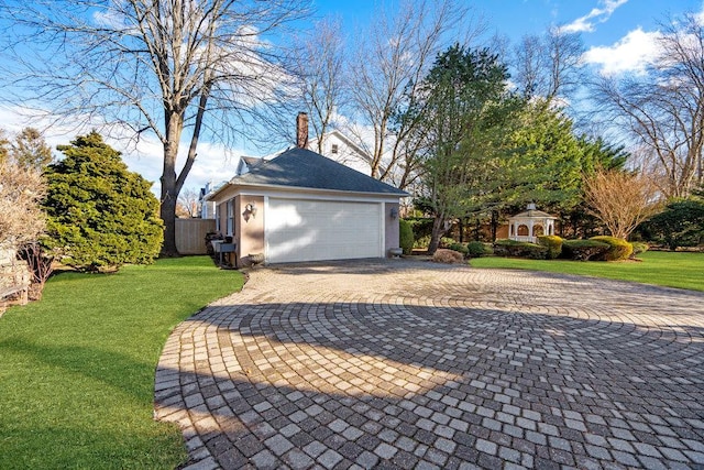 view of home's exterior featuring a yard and a garage