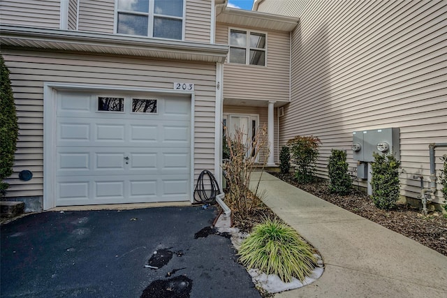 doorway to property with a garage