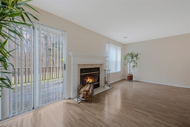 unfurnished living room featuring a fireplace and wood-type flooring