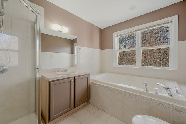 bathroom with vanity, tile patterned flooring, and shower with separate bathtub