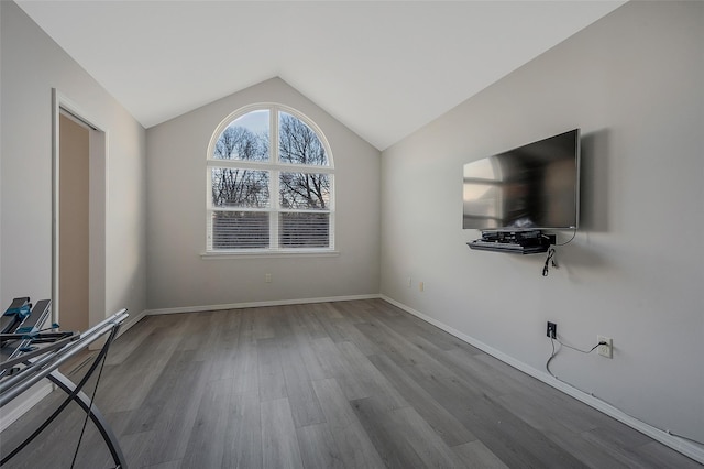 unfurnished living room with light hardwood / wood-style flooring and vaulted ceiling