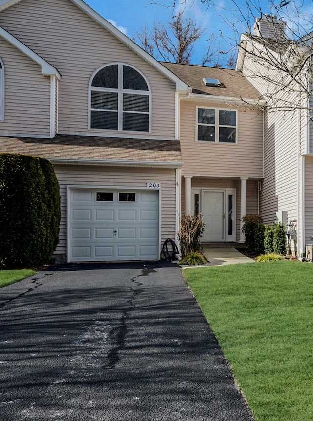 view of front of property featuring a garage and a front yard