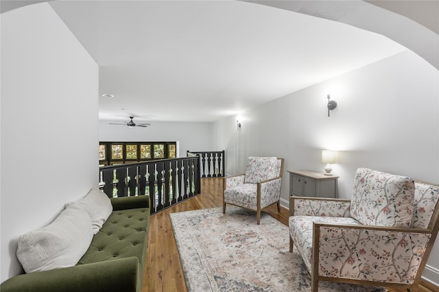 living area with ceiling fan and wood-type flooring