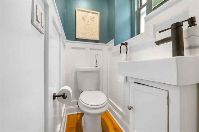 bathroom featuring vanity, hardwood / wood-style floors, and toilet