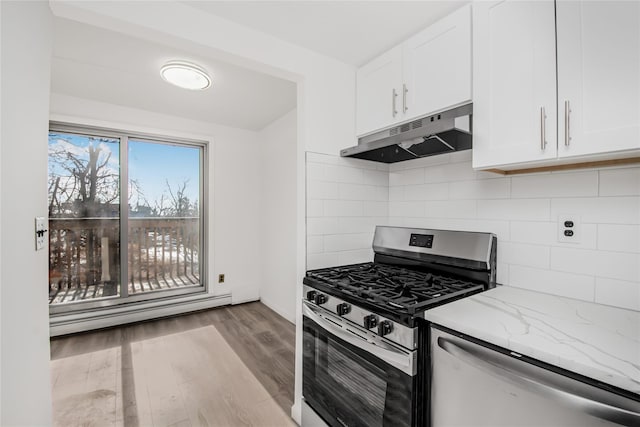 kitchen with a baseboard radiator, white cabinets, tasteful backsplash, light stone countertops, and stainless steel appliances