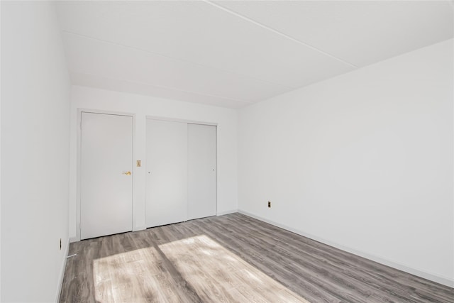 unfurnished bedroom featuring a closet and light wood-type flooring