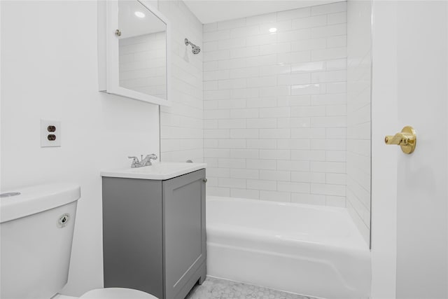 full bathroom with tiled shower / bath combo, toilet, and vanity