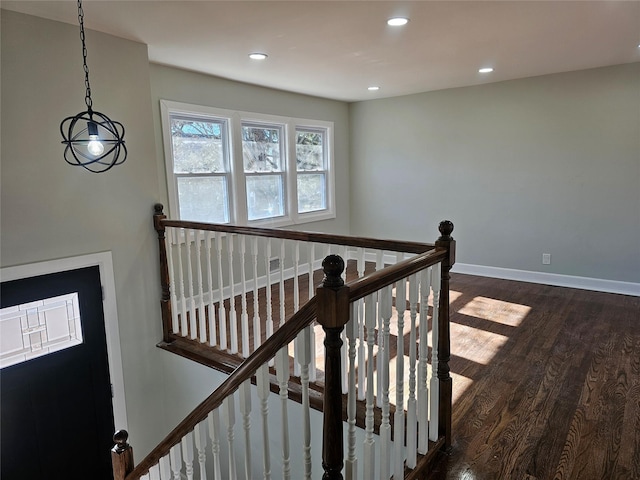 staircase featuring recessed lighting, wood finished floors, and baseboards